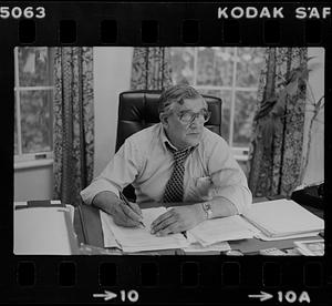 Peter Matthews at desk in office