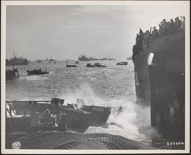 Bulldozer clears a path on Iwo Jima for equipment to be unloaded from LST