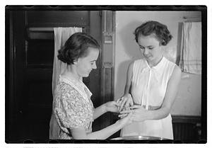 Women doing laundry with a washing machine