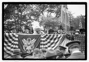 A group of people seated on a reviewing stand including Boston Parks Commissioner William Long