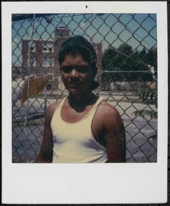 Boy in white tank top outside Newtowne Court