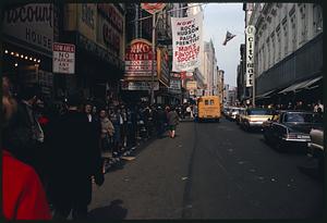 Long line of people on sidewalk outside Paramount Theater for closed-circuit Beatles show, RKO Keith's marquee in background, Boston