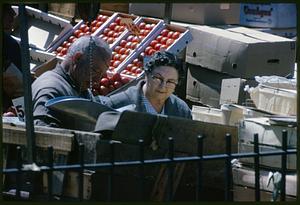 Man and woman standing at outdoor market