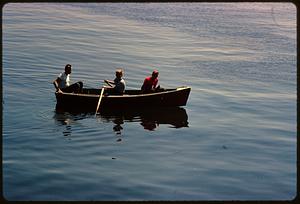 Three boys in rowboat