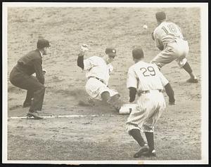 It's a triple -- It was a triple in the ninth inning for Charley Keller, Yankee outfielder and the turning point in the first World Series game between the Yankees and the Cincinnati Reds at New York, Oct 4. Keller is shown sliding into third base while Billy Werber (13) waits for the throw-in. Third base coach Artie Fletcher (29) waits for umpire Babe Pinelli (left) to call the play. A few seconds later Keller scored the winning run of the game when catcher Bill Dickey singled