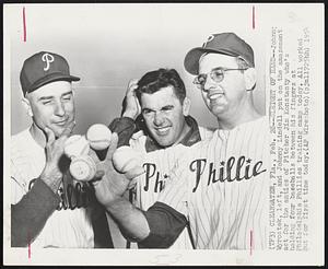Sleight of Hand -- Johnny Wyrostek, left, and Johnny Lindell put on the amazement act for the antics of Pitcher Jim Konstanty who's holding four baseballs between his fingers at Philadelphia Phillies training camp today. All worked out for first time today.