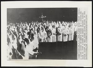 KKK Burn Firey Cross- a large crowd of KKK's stand in a drizzling rain as they listen to Grand Dragon Samuel Green speak as the fiery cross burns in the background.