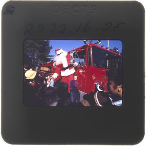Santa Claus greeting campers from a Sharon Fire Truck