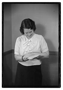 A woman looking down at her hands