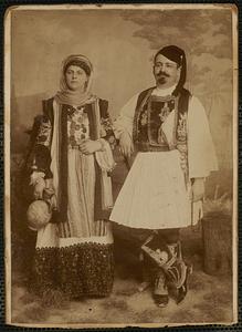 Studio portait of man and woman in traditional Grecian costume
