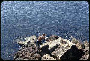 Man swimming from rocks, Naples, Italy