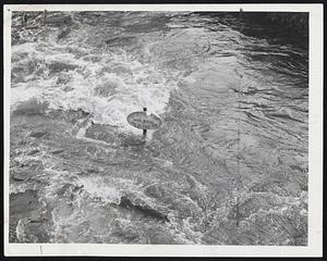 Threatening a Record, the Neponset river late yesterday swirled near the record tidal marker in Dorchester Lower Mills. The plaque notes that in April, 1851, a high tide pushed water to top of rod.