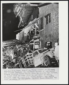 Flood Rescue -- Firemen and rescue workers dig through debris of collapsed Turner Stanton Twine Mills here in search for bodies. At least four persons died in collapse of mill, brought down by rampaging flood waters. One woman died outside.