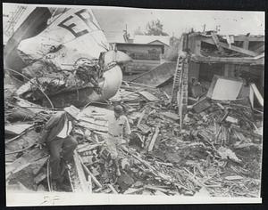 Eight Killed, Six Hurt- Hurricane Hilda's winds crumpled water tank atop City Hall of Erath, La. Rescue workers pulled bodies from debris.