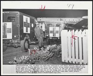 Washington -- Wait To Load -- Two ambulances and their drivers wait on the flight ramp at nearby Andrews Air Force Base before being loaded aboard planes today as an Army field hospital unit is moved out to Cile to the aid of earthquake and tidal wave victims. The unit was one of two being sent to the aid of the South American country in a massive mercy mission airlifted from east coast points.