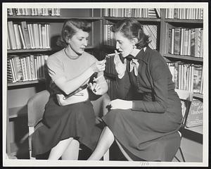 For Its Patrons' Convenience, the Boston Public Library has opened a smoking room on the lower level of its new open shelf department, enjoyed here by Phyllis M. Hoffman (at left) and Marguerite A. Connelly.