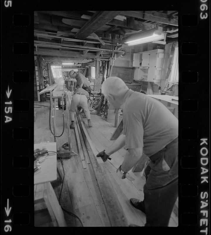 Men working in Pert Lowell's boat shop