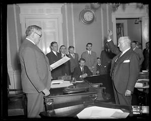 Governor Curley swearing an unidentified man in at State House