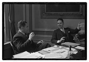 Two men seated at a desk