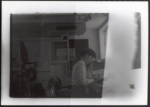 Young man talking on the phone and writing