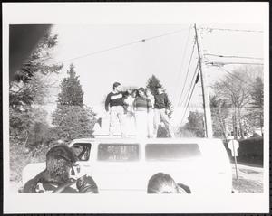 Group of young people standing on a van