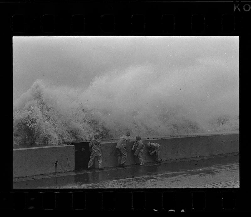 Boys play in nor'easter surf at seawall, Winthrop