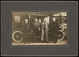 Curtis Hotel: 4 men (including W.A. Curtis) standing in front of an automobile