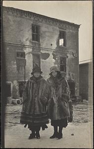 Two women in front of burned-out DuPaw Pharmacy