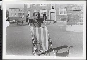 Jared pushing a stroller in Newtowne Court