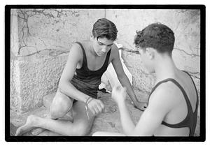 Two unidentified young men playing rock scissor paper