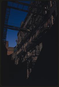 Buildings with elevated walkways and fire escapes