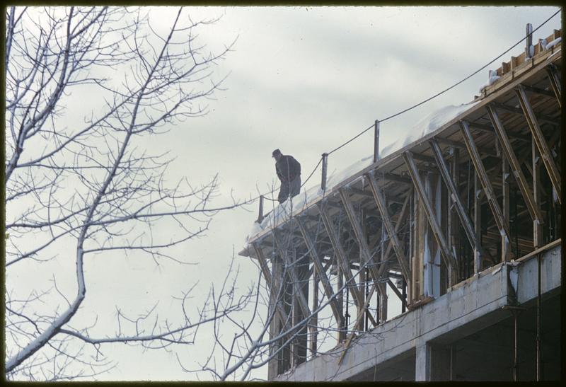 Person standing on roof under construction, Cambridge, Massachusetts