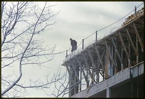 Person standing on roof under construction, Cambridge, Massachusetts