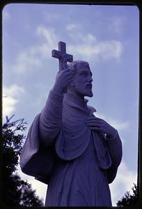 Statue of man holding crucifix