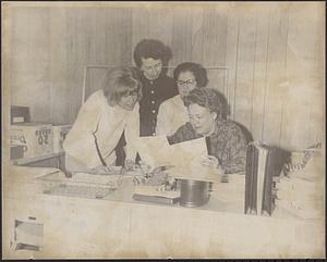 Woman employee at desk, Marilyn Johnson (seated), and Betty Farina