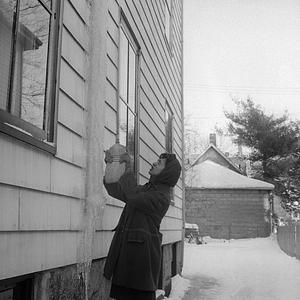 Dorothy Santos removing icicle, 324 Cottage Street, New Bedford