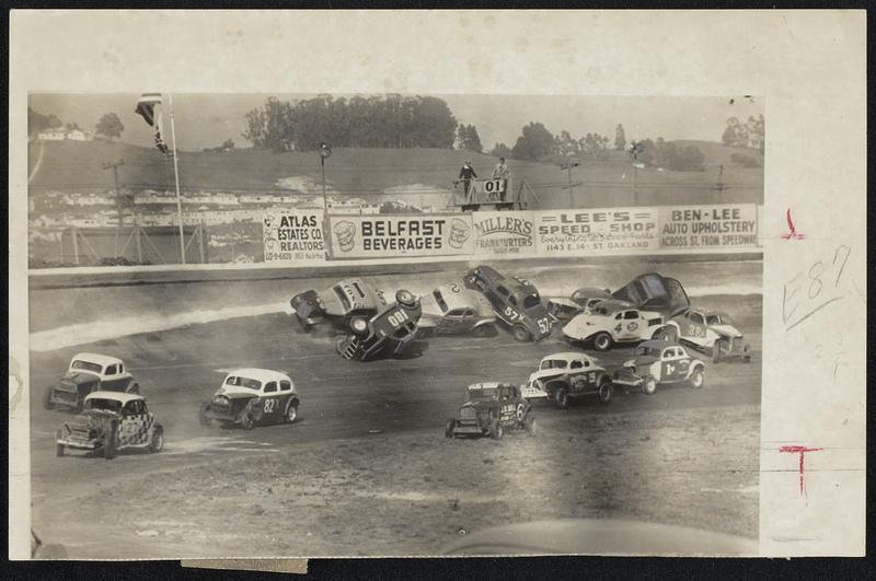 Crack-Up -- Five thousand fans screamed as 11 cars piled up on first lap of semi main event at Oakland, Calif., speedway. Despite the number of cars involved, no one was injured.