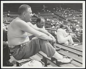 Sitting In The Sun And Liking It are these hardy bleacher fans at Fenway Park, who ignored the management’s invitation at the end of the second inning to come into the shade of the grandstand.