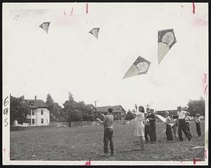 Cambridge Kite Club-These youngsters, members of the Cambridge Kite Club, fly their kites on the playground at Magazine Beach, Cambridge. Plenty of twine may be tangled but the kites are aloft.