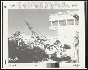 Rescue workers & machinery probe for bodies in rubble of Veterans Administration Hospital, which collapsed during 2/9 quake.