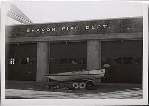 Sharon Fire Department building with the fire department boat in the foreground and the old Sharon Town Hall on the left