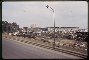 View from the elevated highway, debris in the foreground, piers in the background, current site of Christopher Columbus Waterfront Park, Boston