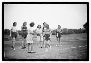 Girls playing a game, possibly kickball