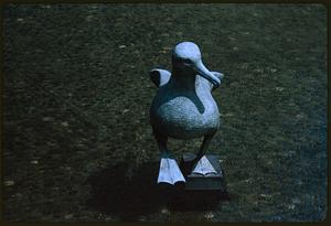 Statue of a bird on small plinth in water, likely Seattle