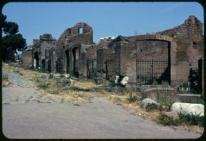 Ruins of brick walls with arches and iron fences