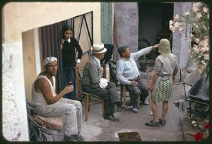 People sitting on porch, Roccasicura, Italy