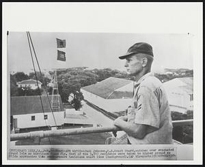 Hurricane Watch--Jack Johnson, U.S. Coast Guard, watches over evacuated Grand Isle as hurricane flags fly. Most of the 3,500 residence were taken to higher ground as Hilda approaches this southernmost Louisiana coast line (background).