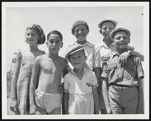 (One Of A Set) – Immigrant Youngsters on Cyprus Smile. This group of smiling youngsters, including the youth second from left who was serious at the moment, typifies the young boys and girls on the Island of Cyprus in the Mediterranean Sea. They are internees at the Caraolos Camp which can accommodate half of the 24,000 Jewish immigrants detained on the island by the British. Most of the young children and the aged have already been sent to Palestine because they are under separate quotas. Other internees now have new hopes since the British formally quit Palestine, ending the 31-year mandate. According to an announcement, May 14, by the Cyprus Government, two Jewish immigrant shops will be released to the Jewish agency, May 15, for use in shipping Jewish immigrants to Palestine.