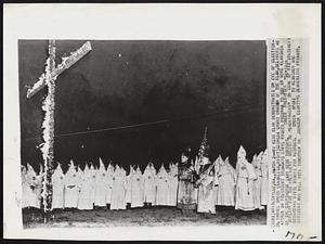 Ku Klux Clan Demonstrates on Eve of Election - Dr. Samuel Green (maskless, right) Georgia Grand Dragon of the Klan, delivers an attack on president Truman's civil rights program to 300 or more klansmen on the courthouse lawn here tonight. Green predicted "certain defeat" for the president unless he "backtracks" on some of his statements regarding civil rights for negroes. Green spoke to klansmen and citizens who will vote tomorrow in Johnson County's democratic primary.