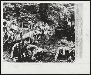 Jap Landslide Buries 75 Persons--Rescue workers dig into the landslide debris which buried 75 persons at Kumonodaira, 65 miles from Tokyo, Japan, Friday. At least 30 are known dead. Kumonodaira is between the city of Karuizawa and Takasaki.